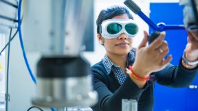 Researcher working with goggles in laboratory.